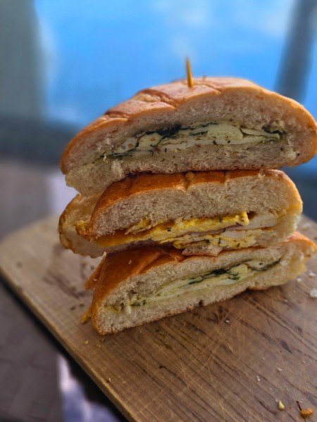 Layered sandwich stack with egg and greens