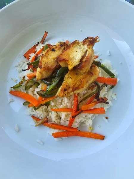Grilled chicken over rice with peppers and carrots